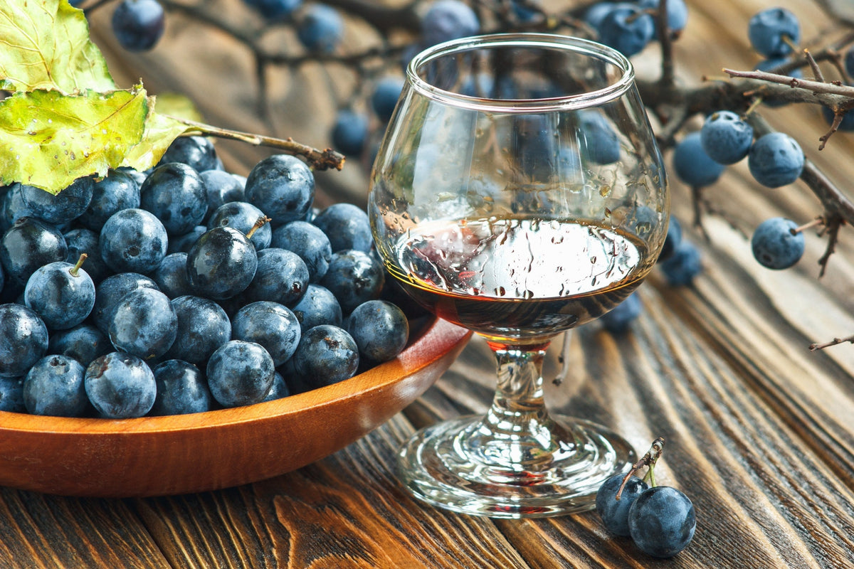 A bowl of juniper berries with Sloe gin.