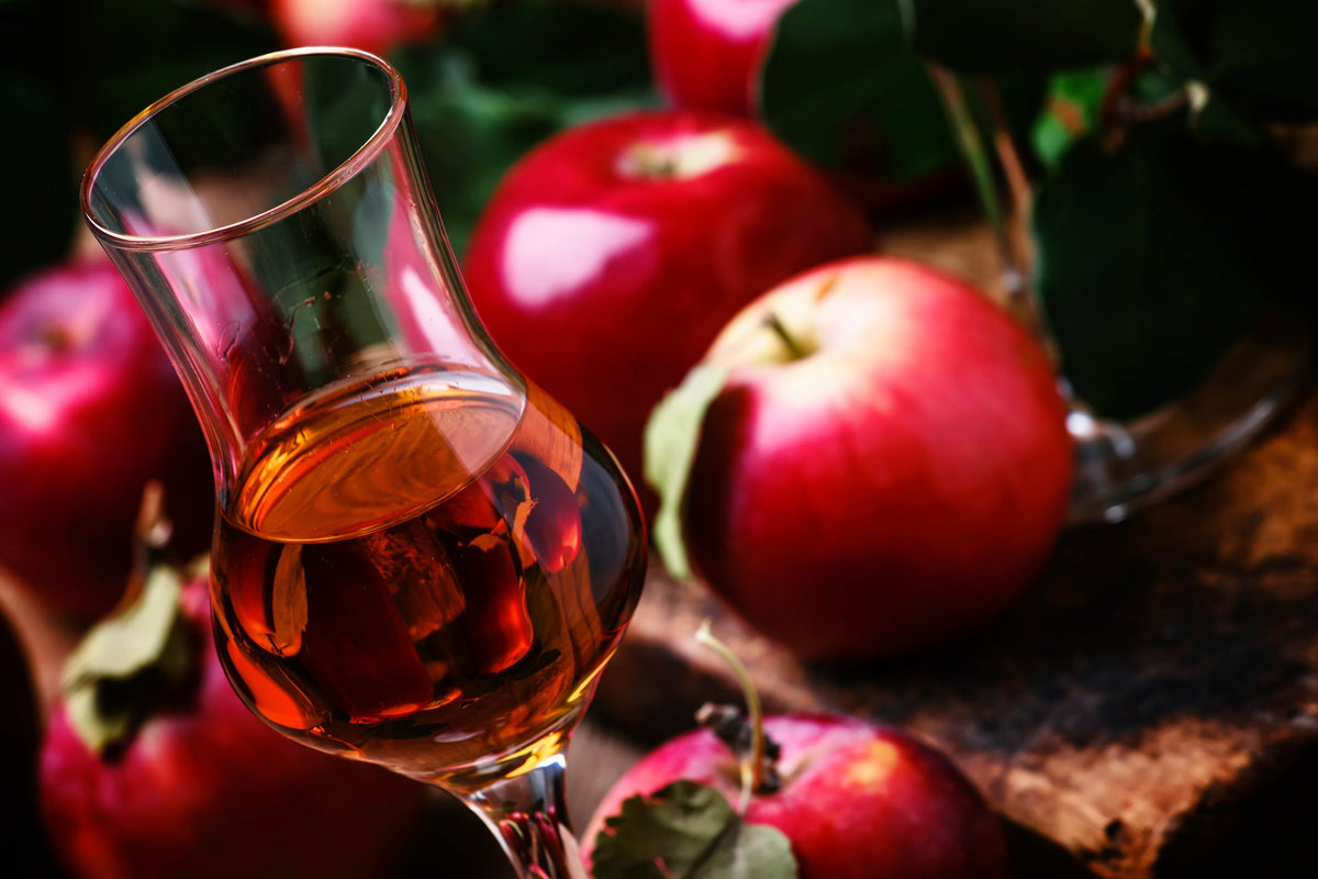 Calvados in glass with apples on the side